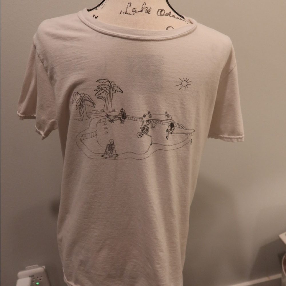 White brandy  t-shirt. Good condition. Skeleton skate park graphic on front